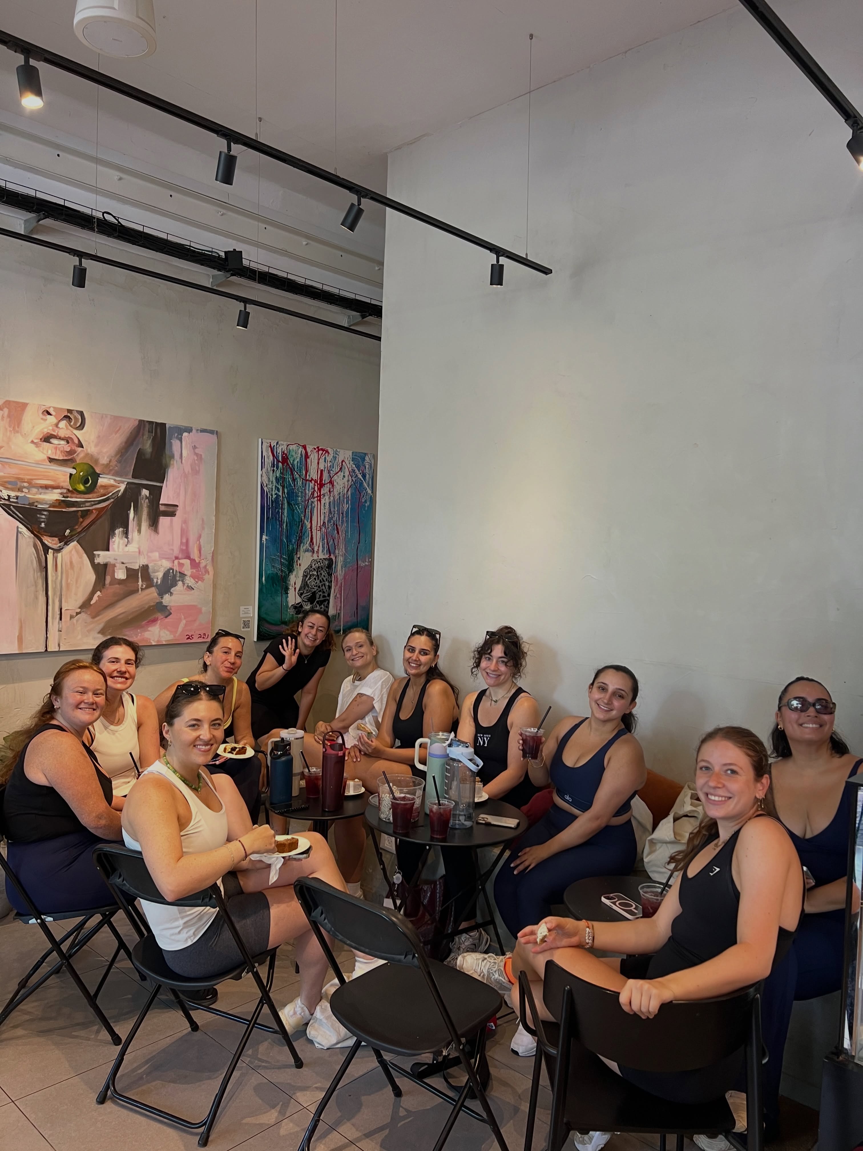 Group of women enjoying drinks together at a cafe post-workout